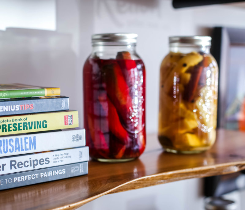 Cookbooks and canned vegetables in jars